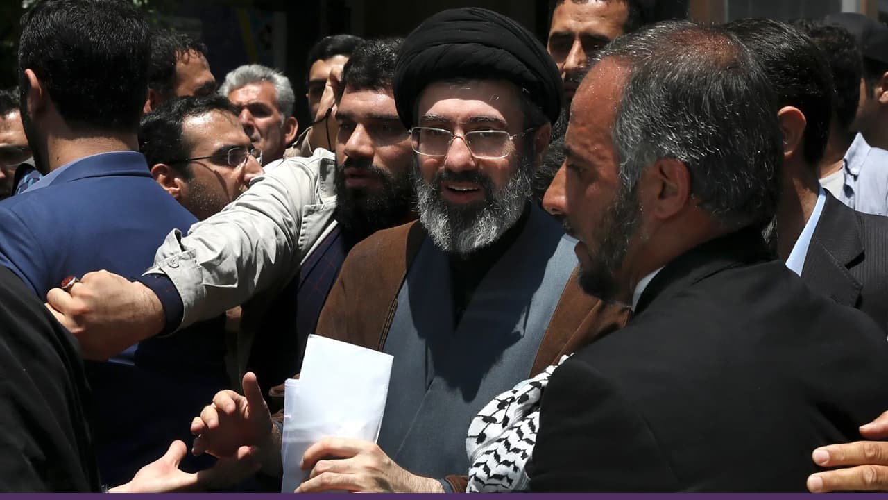 Shia cleric addressing crowd surrounded by security and supporters