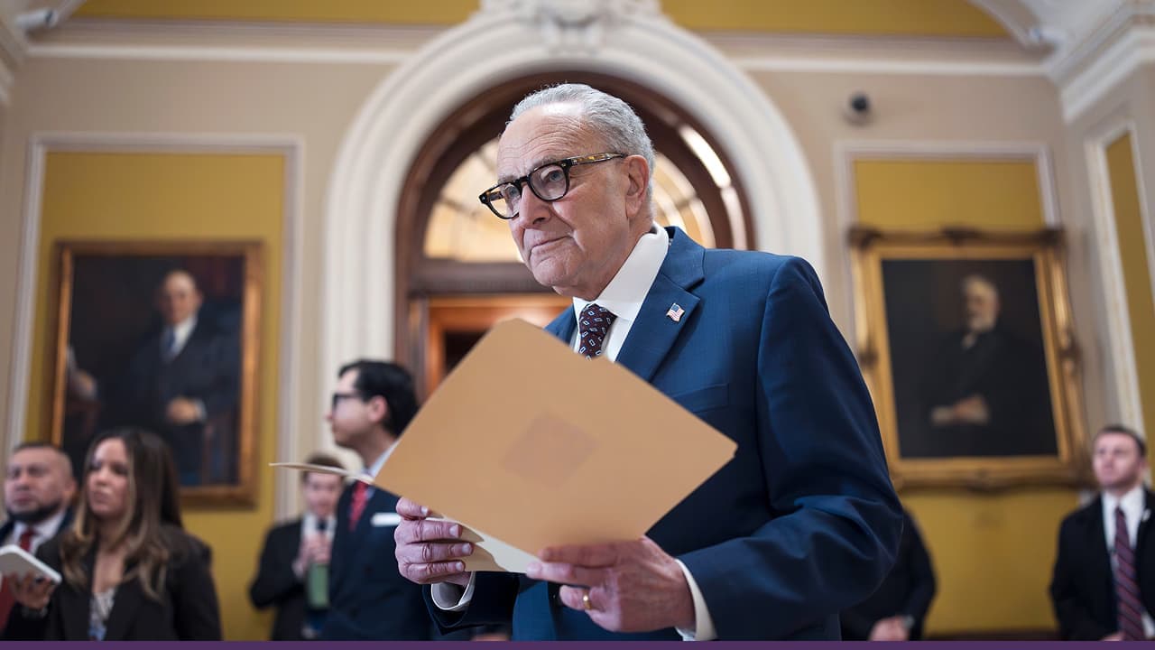 Senate leader reviews documents during bipartisan government funding negotiations