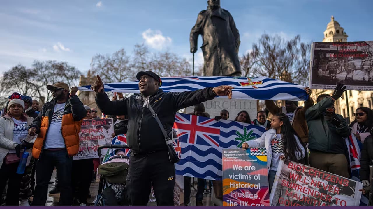 Protesters wave Greek and Union Jack flags at London's Cenotaph, holding "We are victims of genocide" banners during the Chagos Islands sovereignty demonstration