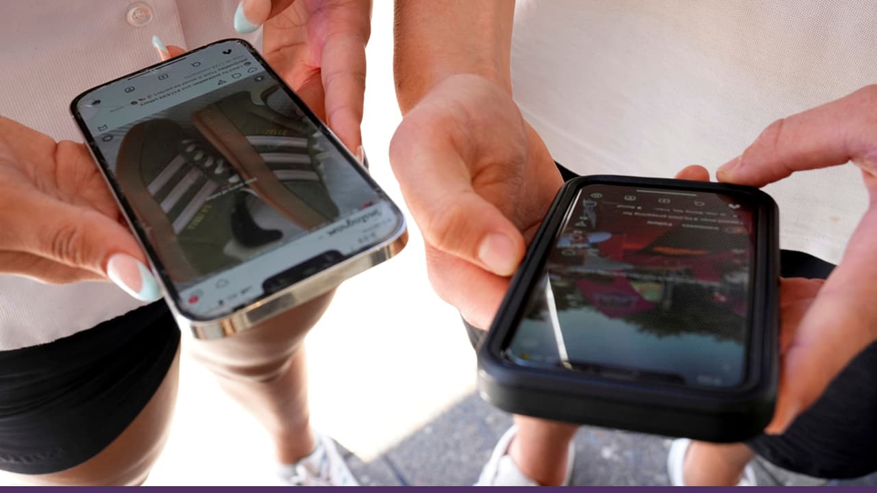 Two people holding smartphones displaying social media content screens